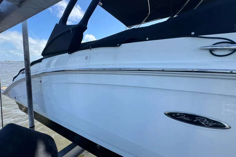 Slide: The Image of 2024 Sea Ray SDX 270 boat with cover, anchored on a sunny day. - 6