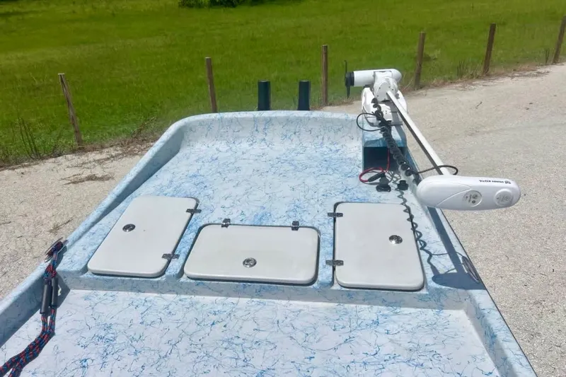 Slide: The Image of 2022 Flats Cat 21' boat deck with storage compartments and trolling motor. - 7