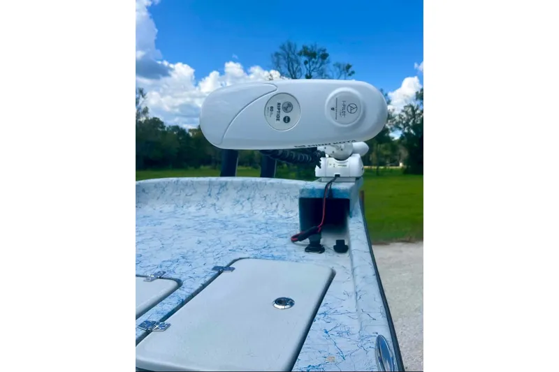 Slide: The Image of 2022 Flats Cat 21' boat deck with mounted equipment under a blue sky. - 8