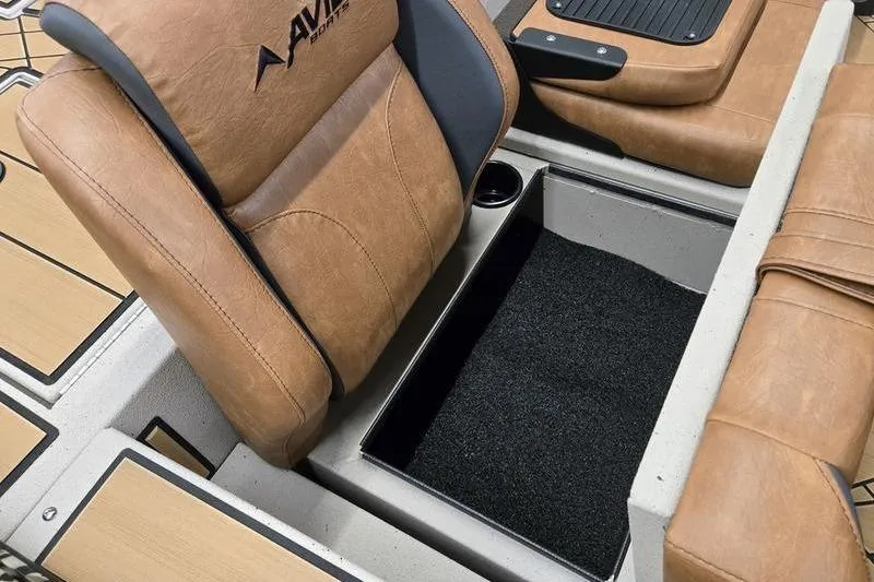 Slide: The Image of 2026 Avid 18 Vertex boat interior with tan leather seats and storage compartment. - 15