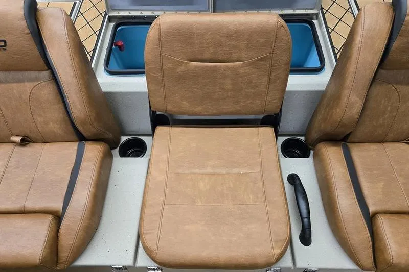 Slide: The Image of Brown leather seats in a 2026 Avid 18 Vertex boat interior. - 16