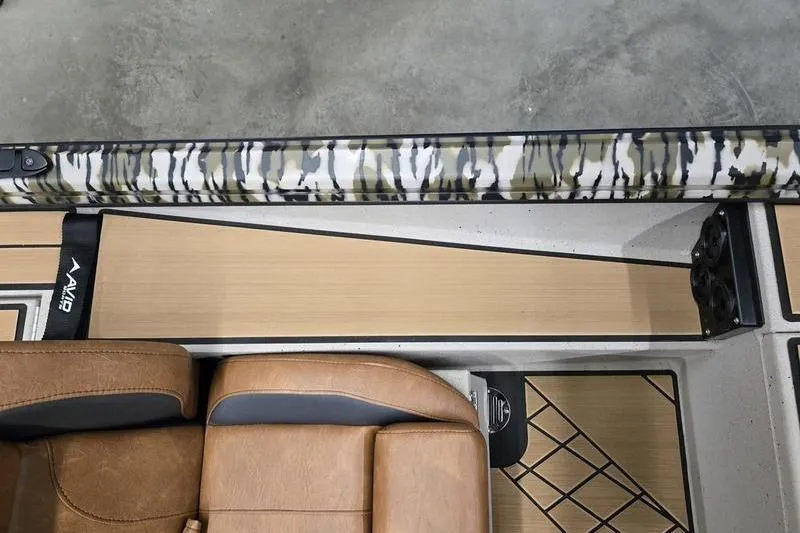 Slide: The Image of 2026 Avid 18 Vertex boat interior with camo accents and tan leather seating. - 17