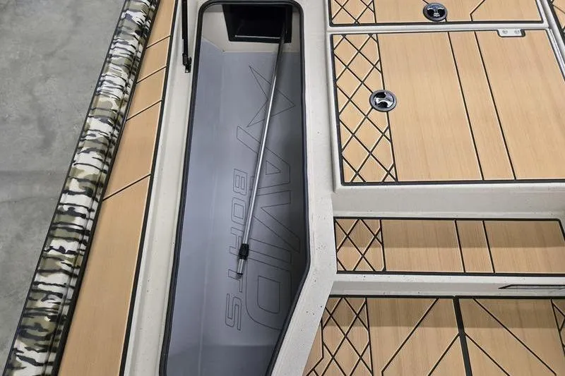 Slide: The Image of 2026 Avid 18 Vertex boat interior with storage compartments and camo detailing. - 19