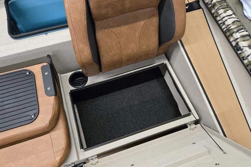Slide: The Image of Avid 18 Vertex 2026 boat interior with storage compartment and brown seating. - 20