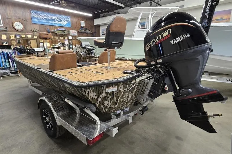 Slide: The Image of 2026 Avid 18 Vertex boat with Yamaha engine in showroom setting. - 3