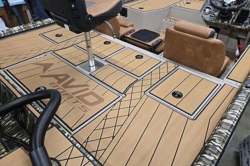 Slide: The Image of 2026 Avid 18 Vertex boat interior with tan seating and custom deck design. - 4