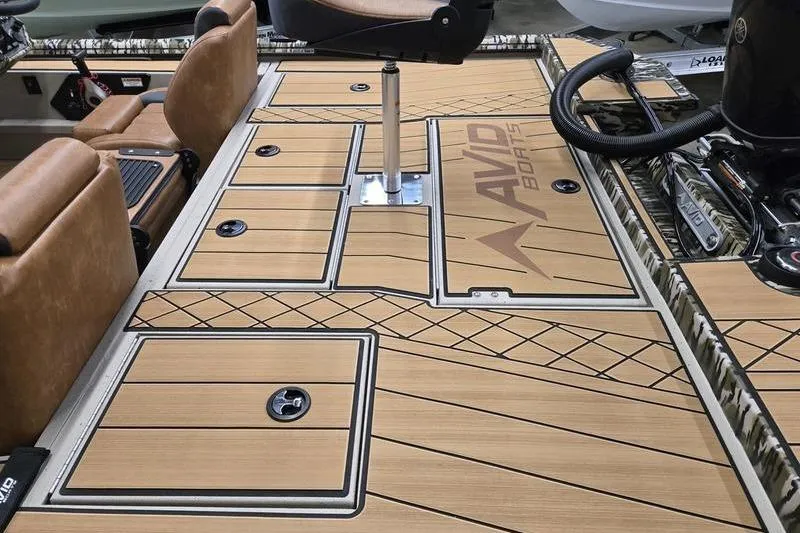 Slide: The Image of Avid 18 Vertex 2026 boat deck with tan seating and storage compartments. - 5
