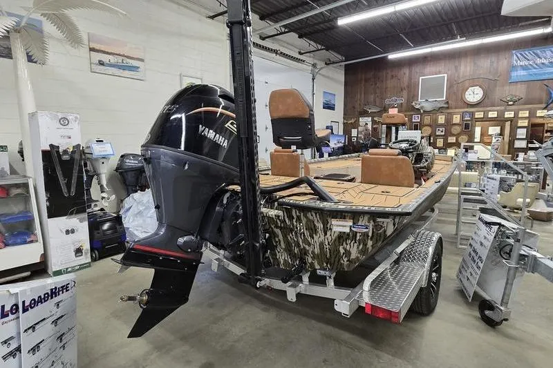 Slide: The Image of 2026 Avid 18 Vertex boat with Yamaha engine in showroom setting. - 7