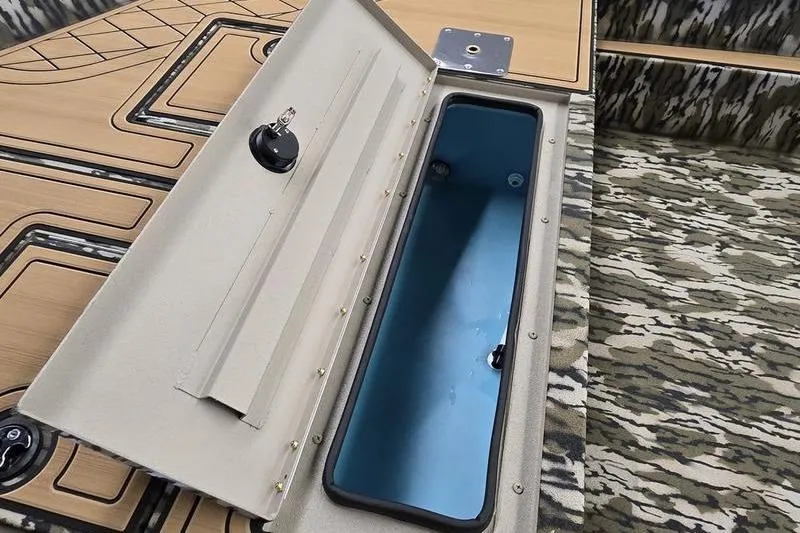 Slide: The Image of Open storage compartment in 2026 Avid 20 Rogue SC boat interior. - 11