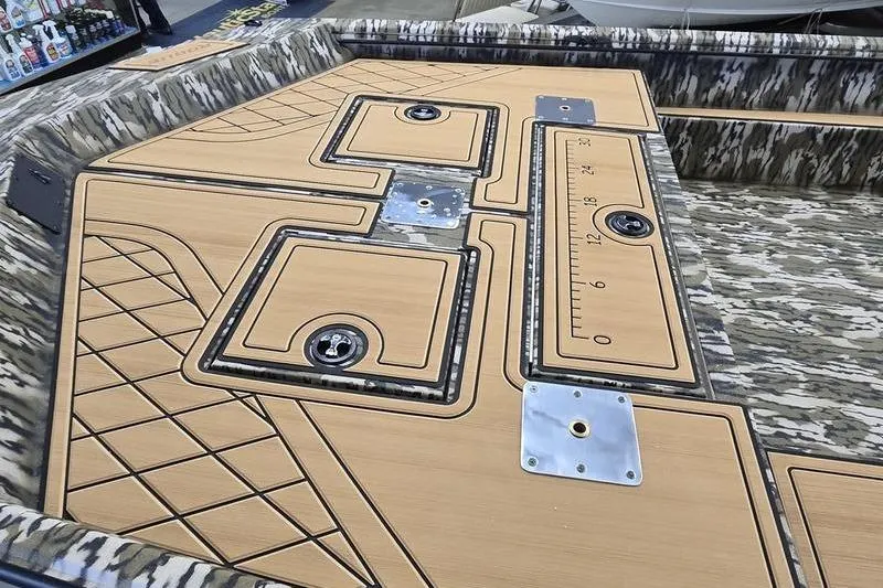 Slide: The Image of 2026 Avid 20 Rogue SC boat deck with camo pattern and measurement markings. - 12