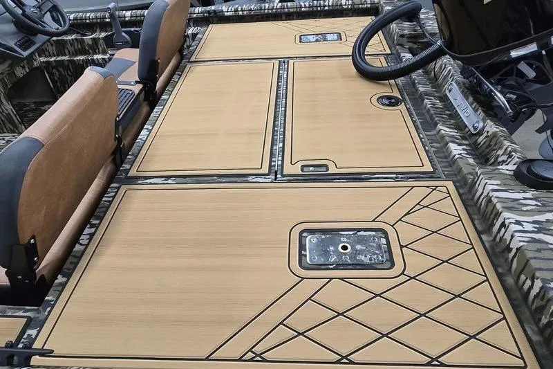 Slide: The Image of 2026 Avid 20 Rogue SC boat interior with camo design and tan seating. - 3