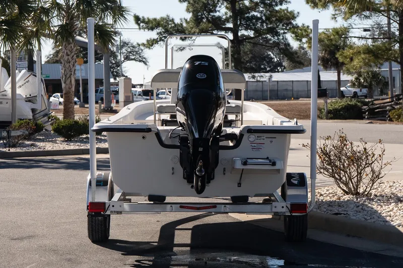 Slide: The Image of 2026 Carolina Skiff E18 JVX CC boat on trailer, rear view, outdoor setting. - 5