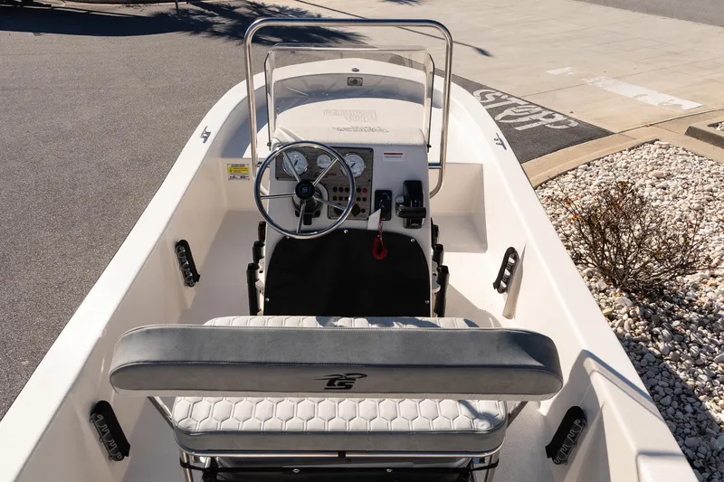 Slide: The Image of 2026 Carolina Skiff E18 JVX CC boat interior with steering wheel and seating. - 8
