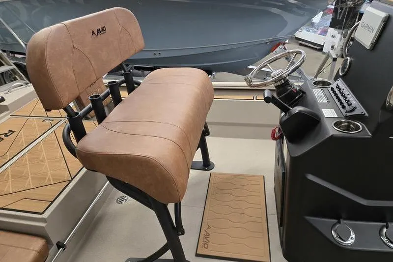 Slide: The Image of Interior of 2026 Avid 22 Rogue CC boat with tan seating and steering console. - 10