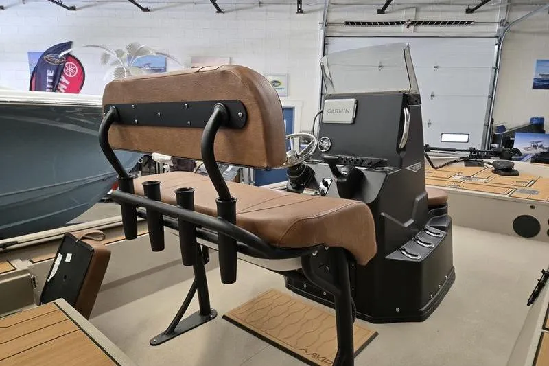 Slide: The Image of 2026 Avid 22 Rogue CC boat interior with brown seating and control console. - 11