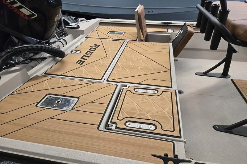 Slide: The Image of 2026 Avid 22 Rogue CC boat deck with wood finish and storage compartments. - 12