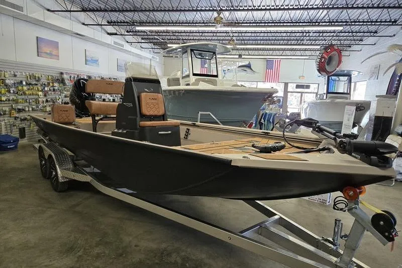 Slide: The Image of 2026 Avid 22 Rogue CC boat displayed in showroom on trailer. - 13