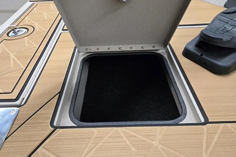 Slide: The Image of Open storage compartment on 2026 Avid 22 Rogue CC boat deck. - 3