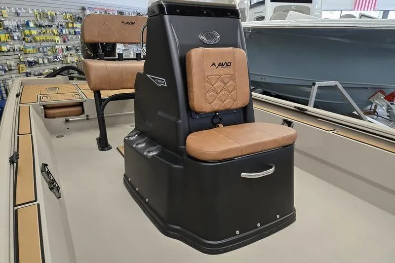 Slide: The Image of 2026 Avid 22 Rogue CC boat interior with tan cushioned seating and storage. - 5