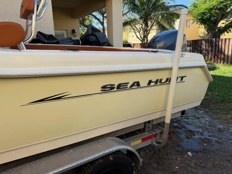 Slide: The Image of 2005 Sea Hunt Triton 232 boat on trailer, parked outdoors. - 10
