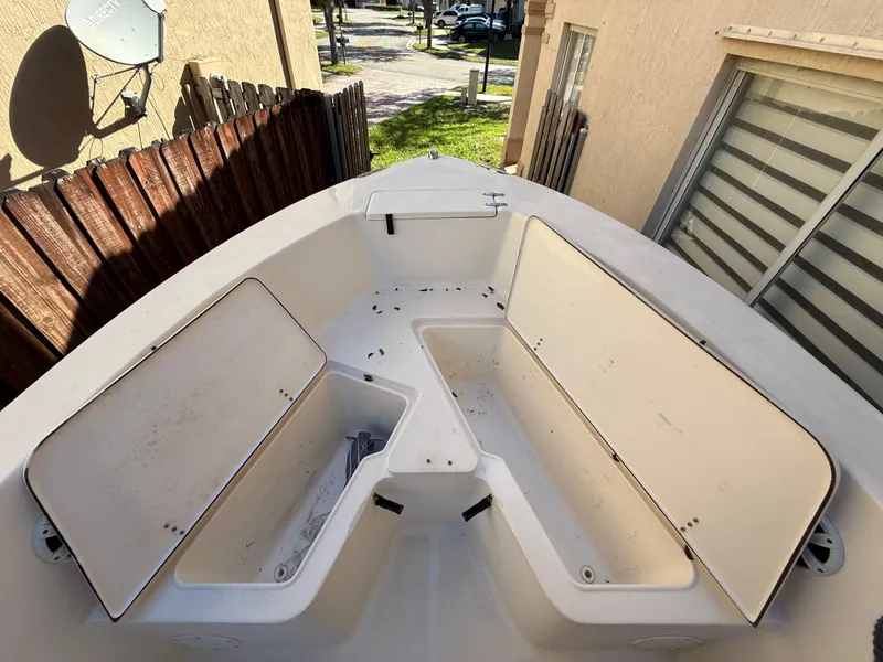 Slide: The Image of 2005 Sea Hunt Triton 232 boat interior with open storage compartments. - 16