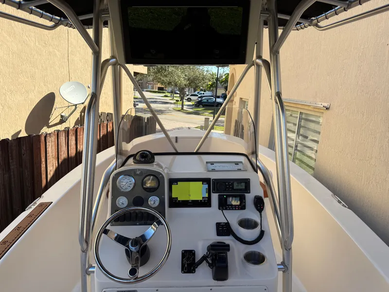 Slide: The Image of 2005 Sea Hunt Triton 232 boat dashboard with steering wheel and navigation equipment. - 18