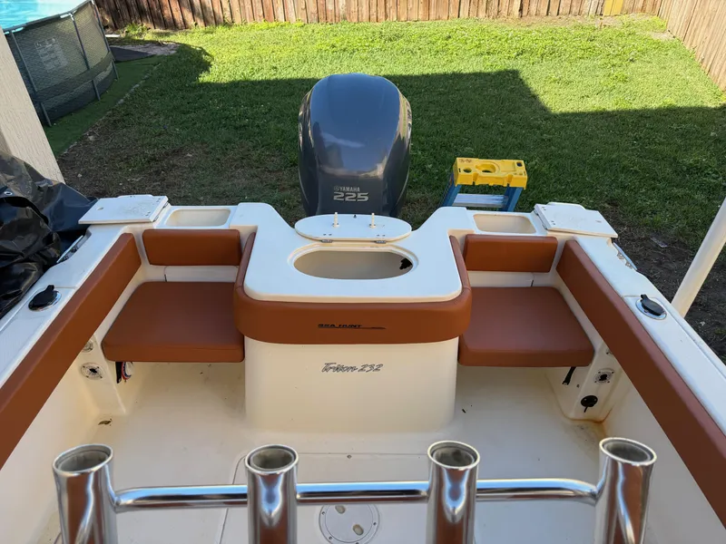 Slide: The Image of 2005 Sea Hunt Triton 232 boat interior with Yamaha 225 engine, outdoor setting. - 23