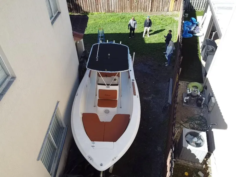 Slide: The Image of 2005 Sea Hunt Triton 232 boat parked between buildings, viewed from above. - 3