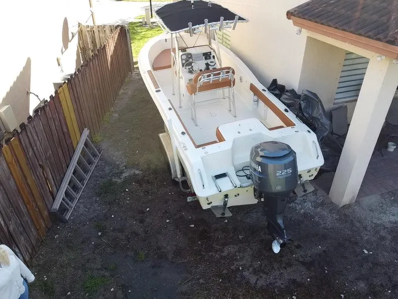 Slide: The Image of 2005 Sea Hunt Triton 232 boat with Yamaha 225 engine, parked outdoors. - 6