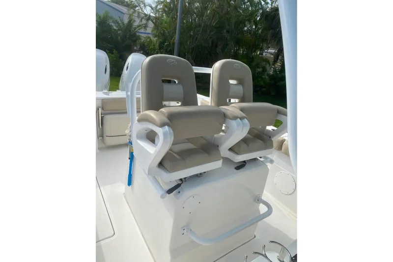 Slide: The Image of 2016 Sea Fox 286 Commander boat seats with beige cushions and white frame. - 6