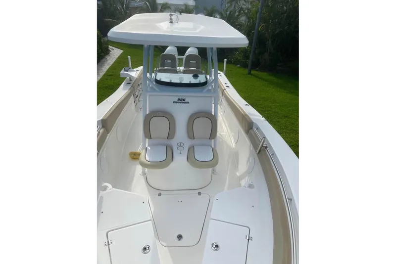 Slide: The Image of 2016 Sea Fox 286 Commander boat interior with seating and console, viewed from the bow. - 8