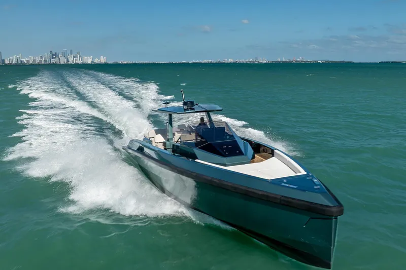 Slide: The Image of 2021 Wally 48 Wally Tender cruising on open water with city skyline in background. - 1