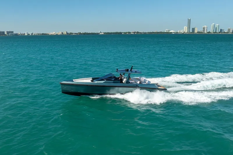 Slide: The Image of 2021 Wally 48 Wally Tender cruising on turquoise waters near city skyline. - 13