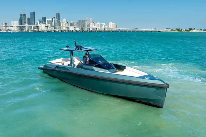 Slide: The Image of 2021 Wally 48 Wally Tender yacht cruising in turquoise waters near a city skyline. - 15
