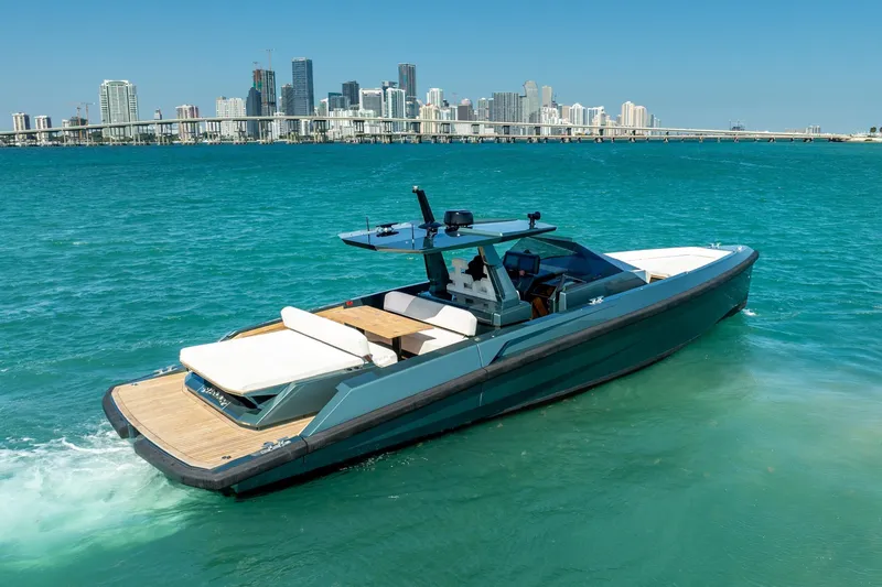 Slide: The Image of 2021 Wally 48 Wally Tender yacht cruising in turquoise waters near a city skyline. - 18