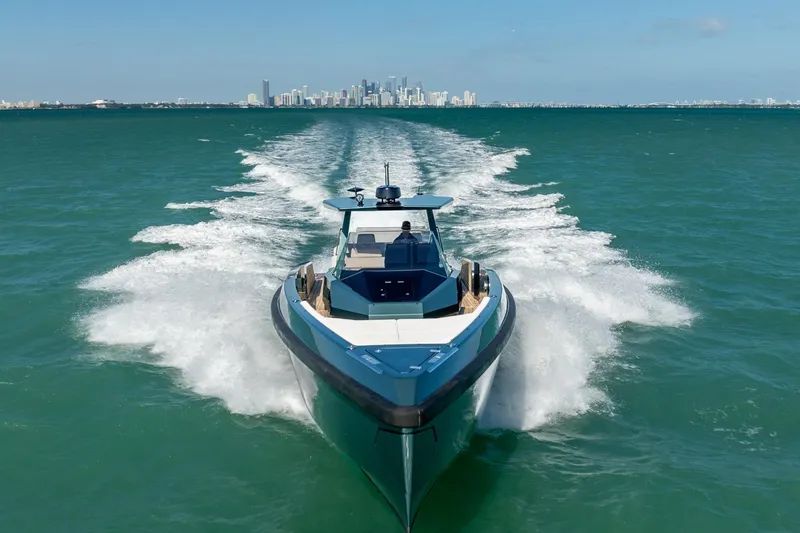 Slide: The Image of 2021 Wally 48 Wally Tender cruising on open water with city skyline in background. - 12