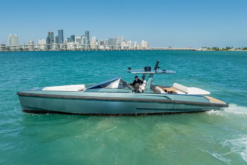 Slide: The Image of 2021 Wally 48 Wally Tender yacht cruising in turquoise waters near a city skyline. - 17