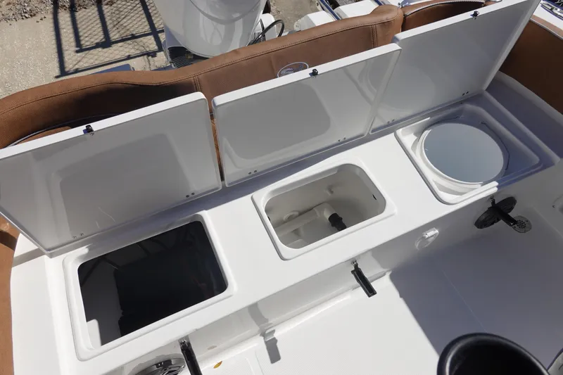 Slide: The Image of 2026 Sea Hunt Ultra 219 boat storage compartments and seating area. - 12