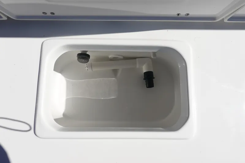 Slide: The Image of Livewell compartment on 2026 Sea Hunt Ultra 219 boat, featuring a clean, white interior. - 14