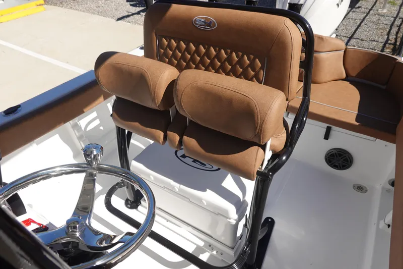 Slide: The Image of 2026 Sea Hunt Ultra 219 boat interior with brown cushioned seating and steering wheel. - 19