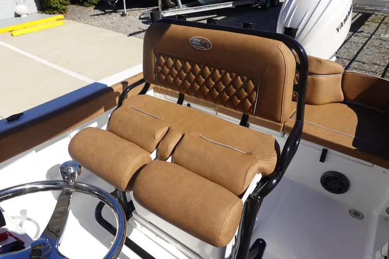 Slide: The Image of 2026 Sea Hunt Ultra 219 boat interior with tan leather seating and steering wheel. - 20