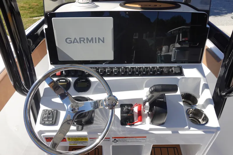 Slide: The Image of 2026 Sea Hunt Ultra 219 boat dashboard with Garmin display and Yamaha controls. - 22