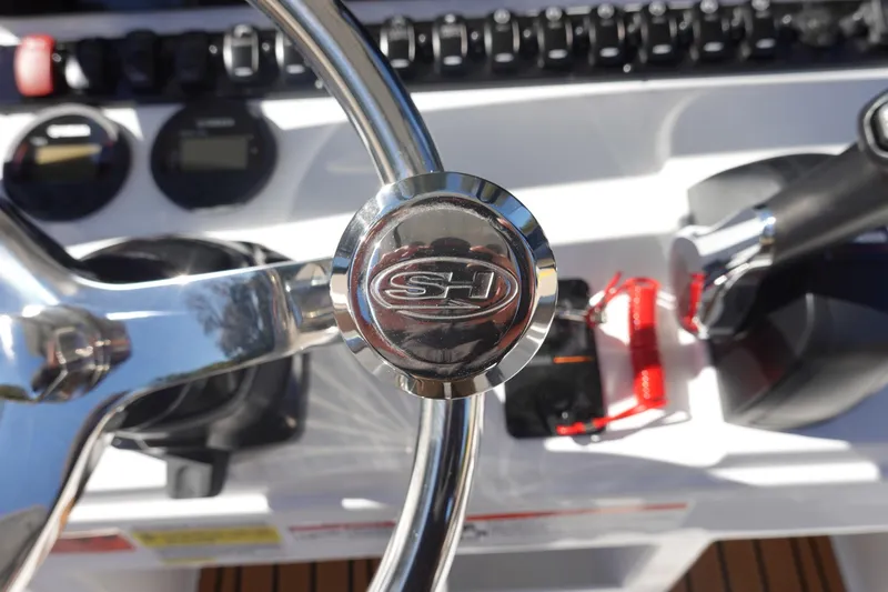 Slide: The Image of Steering wheel of 2026 Sea Hunt Ultra 219 boat with control panel. - 23