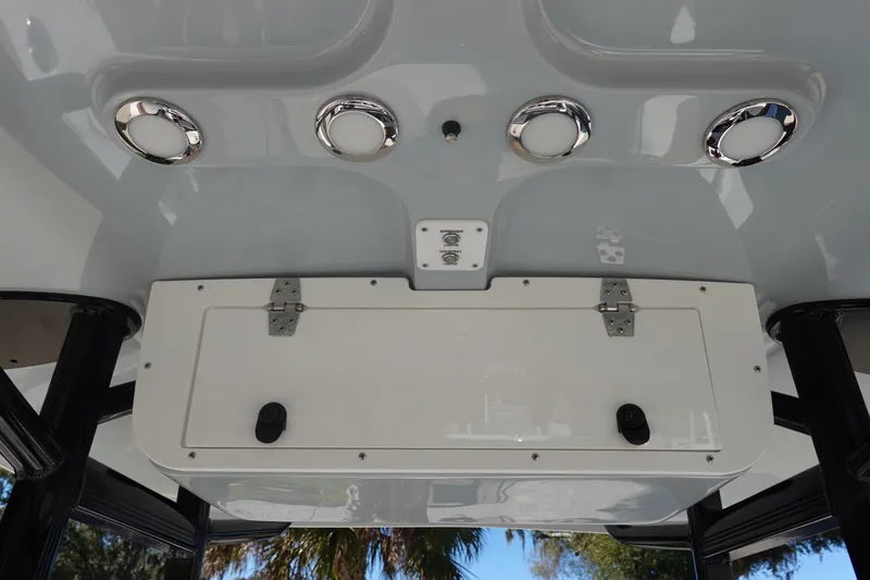Slide: The Image of 2026 Sea Hunt Ultra 219 boat console with storage compartment and chrome fixtures. - 24