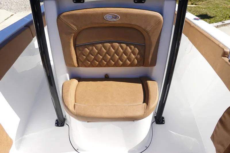 Slide: The Image of 2026 Sea Hunt Ultra 219 boat interior with tan cushioned seating and elegant design. - 28