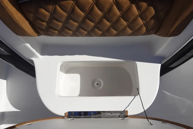 Slide: The Image of 2026 Sea Hunt Ultra 219 boat interior with brown quilted seating and white compartment. - 29