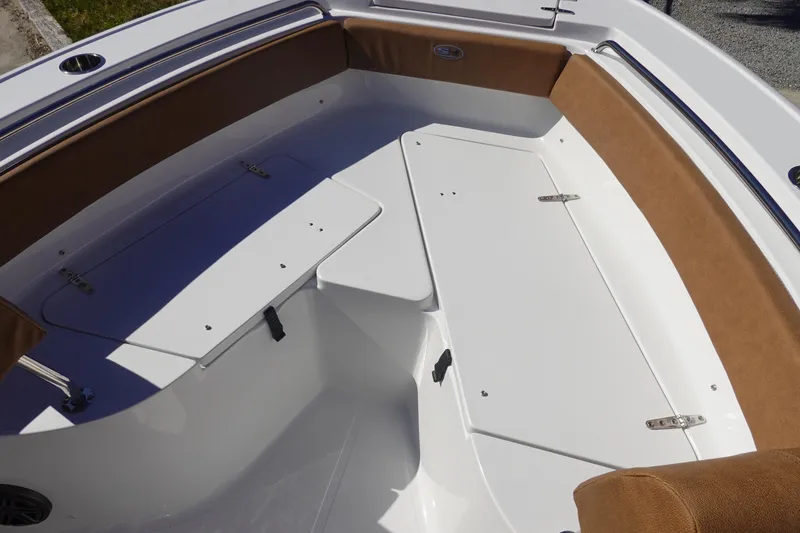 Slide: The Image of Interior view of 2026 Sea Hunt Ultra 219 boat, featuring cushioned seating and storage compartments. - 32