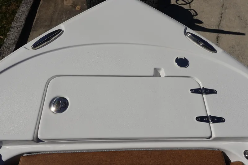 Slide: The Image of 2026 Sea Hunt Ultra 219 boat deck with storage compartment and stainless steel fittings. - 36