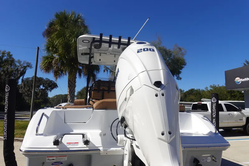 Slide: The Image of 2026 Sea Hunt Ultra 219 boat with powerful outboard motor, parked outdoors. - 5
