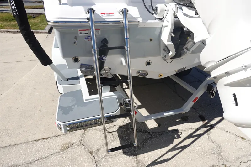 Slide: The Image of 2026 Sea Hunt Ultra 219 boat with ladder and motor details. - 7